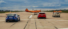 Scene from a show featuring drift cars, racing cars and airplanes