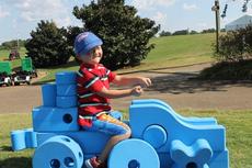 Kid playing at KaBOOM booth at 2104 Yokohama Tire LPGA Classic
