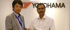 YIN President Satoshi Fujitsu presenting donation check to Indian Red Cross Deputy Secretary Mr. P.C. Partihari (right)
