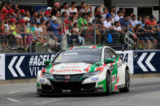 Crowds cheer leading car